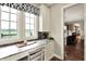 Desk nook featuring marble countertop, window with a view, and a glimpse of the kitchen at 1581 S 825 E, Zionsville, IN 46077