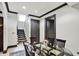 Dining area shows access to the upper level stairs with light grey walls and dark trim at 1581 S 825 E, Zionsville, IN 46077
