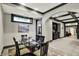 Elegant dining area featuring a glass table, dark trim, and a view to exercise room at 1581 S 825 E, Zionsville, IN 46077