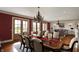 Formal dining room with a large table, elegant chandelier, and views of the expansive yard at 1581 S 825 E, Zionsville, IN 46077