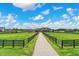Sprawling estate features a long driveway leading to a stone home surrounded by green pastures at 1581 S 825 E, Zionsville, IN 46077
