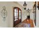 Grand foyer with wood floors, elegant lighting fixtures, and a view of the picturesque property at 1581 S 825 E, Zionsville, IN 46077