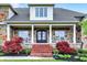Close-up of porch entrance with brick stairs and lush landscaping at 1581 S 825 E, Zionsville, IN 46077