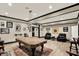Spacious game room with pool table, wood floors, adjacent seating and dart board at 1581 S 825 E, Zionsville, IN 46077