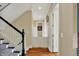 Hallway featuring hardwood floors and a staircase with a black handrail at 1581 S 825 E, Zionsville, IN 46077