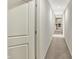 Long hallway with light carpet and doors, leading towards other rooms in the home at 1581 S 825 E, Zionsville, IN 46077