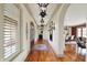 Elegant hallway with hardwood floors, arched doorways, and stylish lighting fixtures at 1581 S 825 E, Zionsville, IN 46077