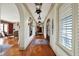 Spacious hallway featuring hardwood floors, detailed molding, and sophisticated lighting fixtures at 1581 S 825 E, Zionsville, IN 46077