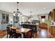 Open concept kitchen with a center island, hardwood floors, and pendant lighting at 1581 S 825 E, Zionsville, IN 46077