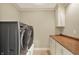 Laundry room with front load washer and dryer, storage cabinets, and countertop space at 1581 S 825 E, Zionsville, IN 46077