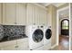 Well-equipped laundry room with modern washer and dryer, granite countertops, and storage at 1581 S 825 E, Zionsville, IN 46077
