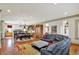Open concept living area with hardwood floors, a kitchen, and a large leather sofa at 1581 S 825 E, Zionsville, IN 46077