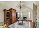 Chandelier-lit living area boasts a fireplace, hardwood floors, and exquisite furnishings at 1581 S 825 E, Zionsville, IN 46077