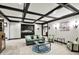 Well-lit living room boasts coffered ceilings, and a stylish seating area with an accent rug at 1581 S 825 E, Zionsville, IN 46077