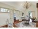 Elegant living room featuring hardwood floors, ornate chandelier, and seamless flow to adjacent rooms at 1581 S 825 E, Zionsville, IN 46077