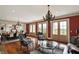 Spacious living room with a decorative chandelier, beautiful hardwood floors, and large windows at 1581 S 825 E, Zionsville, IN 46077
