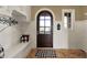 Inviting mudroom showcases built-in bench, arched front door and view of the yard at 1581 S 825 E, Zionsville, IN 46077