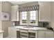 Office area with built-in cabinets, a large window, and a granite countertop at 1581 S 825 E, Zionsville, IN 46077
