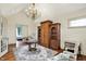 Bright office with a chandelier, hardwood floors, wooden wardrobe, and desk at 1581 S 825 E, Zionsville, IN 46077