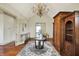 Large office with hardwood floors, a chandelier, an area rug, and desk at 1581 S 825 E, Zionsville, IN 46077