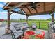 Covered outdoor living space with a fan, grill, comfortable seating, and a view of the yard at 1581 S 825 E, Zionsville, IN 46077