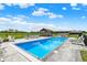 Gorgeous in-ground pool features lounge chairs, open-air structure, and patio furniture for a relaxing outdoor experience at 1581 S 825 E, Zionsville, IN 46077