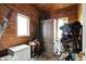 Cozy tack room with wood-paneled walls, windows, and storage, offering a functional space for equestrian equipment at 1581 S 825 E, Zionsville, IN 46077