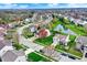 Aerial view of a charming residential neighborhood with lush greenery and a scenic pond at 15890 Concert Way, Noblesville, IN 46060