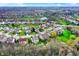 Sprawling suburban community with well-kept homes, lush green spaces, and a serene pond reflecting the sky at 15890 Concert Way, Noblesville, IN 46060