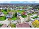 Aerial view of a well-maintained suburban neighborhood featuring manicured lawns and mature trees in spring at 15890 Concert Way, Noblesville, IN 46060