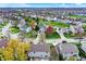 Serene aerial view of homes in a picturesque neighborhood with lush greenery and a tranquil pond at 15890 Concert Way, Noblesville, IN 46060