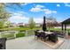 A back deck with outdoor furniture overlooking a serene pond and lush green landscaping at 15890 Concert Way, Noblesville, IN 46060