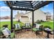 Charming backyard patio with comfortable seating area and pergola, perfect for outdoor relaxation and entertaining at 15890 Concert Way, Noblesville, IN 46060