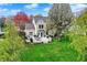 Aerial view of a well-maintained backyard with a deck, patio, and mature trees, perfect for outdoor enjoyment at 15890 Concert Way, Noblesville, IN 46060