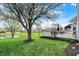 Landscaped backyard featuring a pond view, deck, and mature trees, creating a serene outdoor oasis at 15890 Concert Way, Noblesville, IN 46060