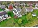 Aerial view of a home's spacious backyard, featuring a patio, deck, and mature trees at 15890 Concert Way, Noblesville, IN 46060