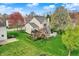 Aerial view highlighting the manicured lawn, pergola and deck in the serene backyard at 15890 Concert Way, Noblesville, IN 46060