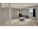 Finished basement area features neutral carpet, column, track lights, and a window with a curtain at 15890 Concert Way, Noblesville, IN 46060