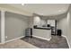 Basement area featuring a wine cooler, bar counter, stainless steel fridge, and dark ceramic tile at 15890 Concert Way, Noblesville, IN 46060