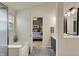 Bright bathroom with a soaking tub and tile flooring, complemented by a view into the bedroom at 15890 Concert Way, Noblesville, IN 46060