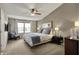 Inviting bedroom with a ceiling fan, neutral tones, and natural light, creating a serene atmosphere at 15890 Concert Way, Noblesville, IN 46060