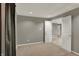 A bedroom featuring neutral carpet, gray walls, a ceiling light, and an open doorway at 15890 Concert Way, Noblesville, IN 46060