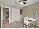 Bright bedroom with a modern desk, closet with bi-fold doors, and ceiling fan at 15890 Concert Way, Noblesville, IN 46060