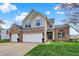 Beautiful two-story house with brick accents, attached garages, and landscaped front yard at 15890 Concert Way, Noblesville, IN 46060