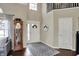 Grand foyer boasts soaring ceilings, elegant staircase, hardwood floors, and charming decor at 15890 Concert Way, Noblesville, IN 46060
