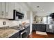 Well-lit kitchen with a stove top, stainless steel appliances, and granite countertops at 15890 Concert Way, Noblesville, IN 46060