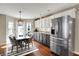 Bright kitchen with a dining table, stainless steel fridge, and hardwood floors at 15890 Concert Way, Noblesville, IN 46060