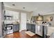 Open kitchen layout with island, stainless steel appliances, and seamless flow into the living area at 15890 Concert Way, Noblesville, IN 46060