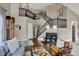 Open-concept living area with hardwood floors, tall ceilings, staircase and modern chandelier at 15890 Concert Way, Noblesville, IN 46060