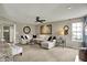 Cozy living room with plush seating, ceiling fan and natural light at 15890 Concert Way, Noblesville, IN 46060